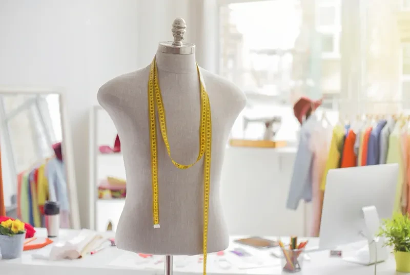 Fashion design studio with dress form and measuring tape